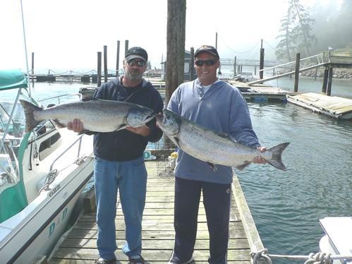 Two happy D&D Fishing Charters customers with their big beautiful Chinook salmon