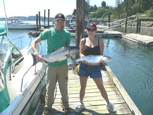 Two happy D&D Fishing Charters customers with their catch of salmon
